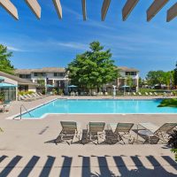 A swimming pool and lounge chairs on a sunny day