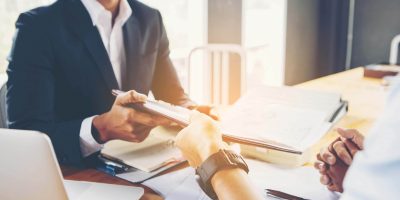 A man and woman looking at a day planner